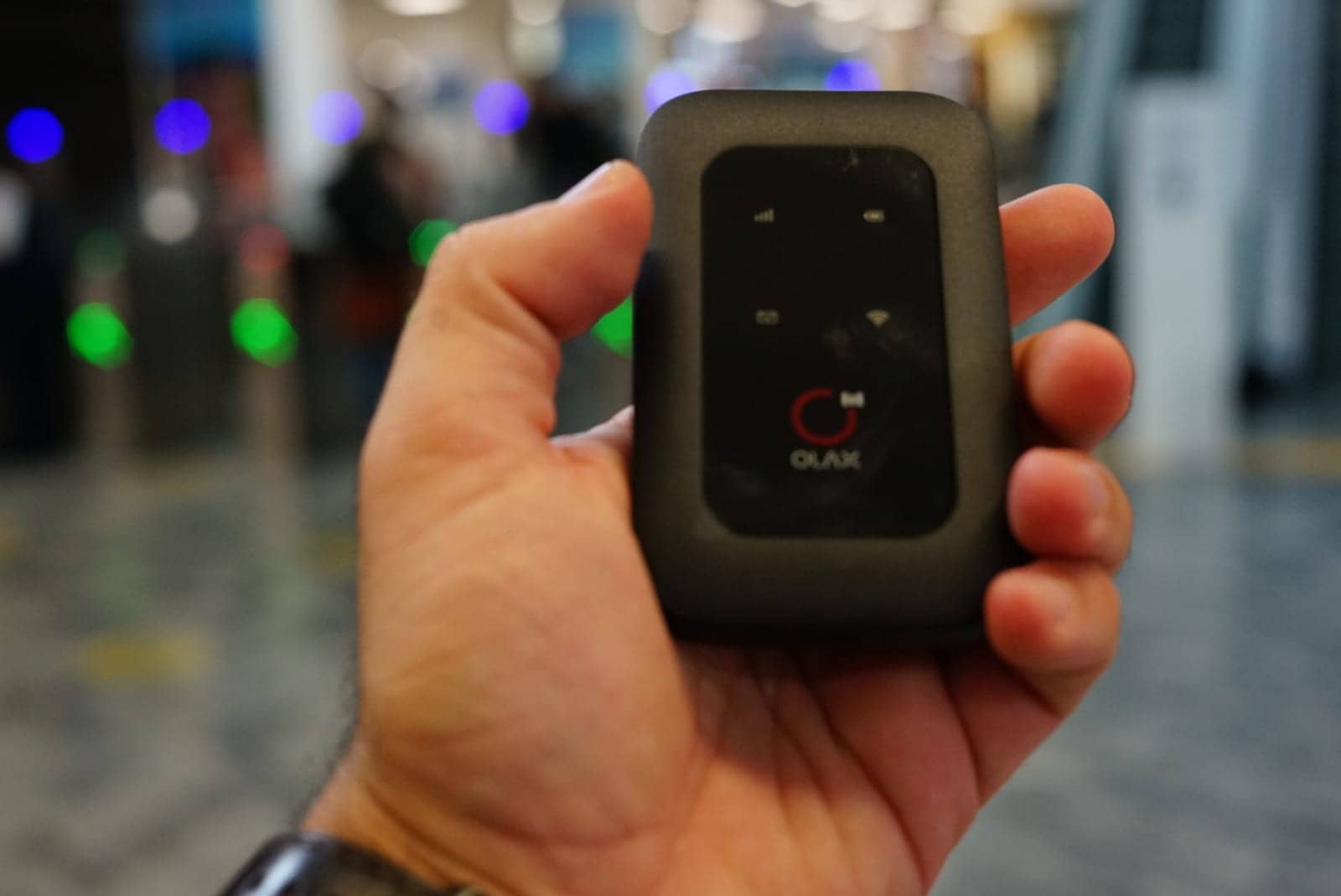 A pocket wifi hotspot held in one hand